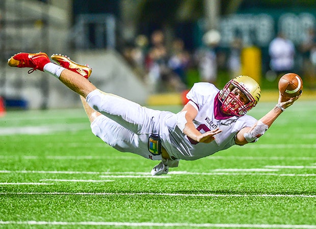 Cypress Woods (Texas) quarterback Bryson Powers dives while attempting a 2-point conversion pass.