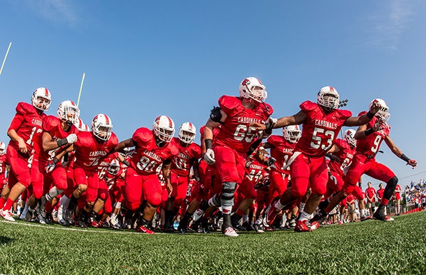 Colerain (Ohio) players rush the field before their home game against St. Xavier.