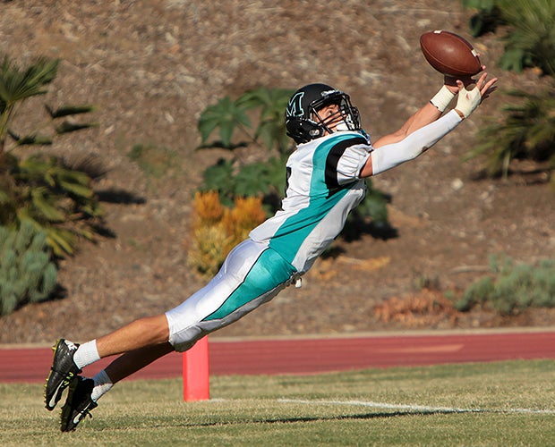 Malibu (Calif.) receiver Luca Marinaro dives while catching a touchdown pass against Brentwood School.
