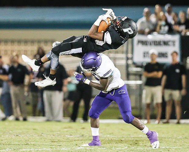 Providence (Fla.) receiver Sam Carrol is upended by a Fletcher defender.