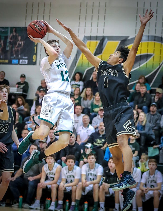 Rhys Pulling of Mountain Vista (Colo.) takes a running shot while defended by Jalen Ashley of Rock Canyon.
