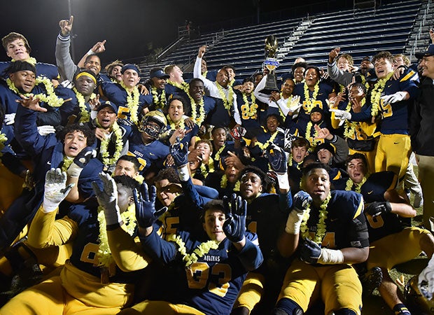 Aquinas players celebrate their GEICO State Champions Bowl Series victory in Las Vegas.