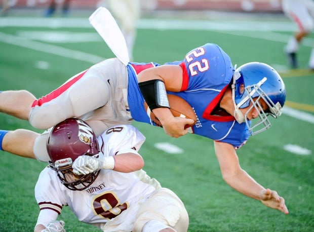 Hunter Jury, a JV player for Christian Brothers (Sacramento, Calif.) runs over a Whitney (Rocklin, Calif.) defender.