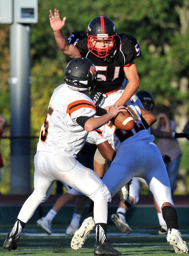 Mamaroneck (N.Y.) quarterback Daniel Gottlieb has a Fox Lane (Bedford, N.Y.) defender leap into his face.