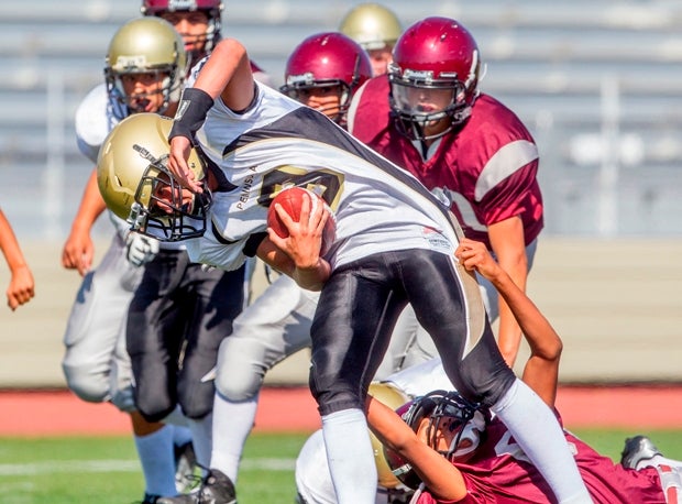 A Palos Verdes Peninsula (Rolling Hills, Calif.) player twists away from a Torrance (Calif.) tackler.