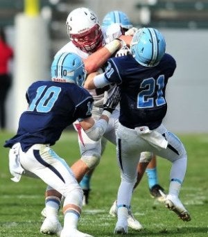 Corona del Mar's Brett Greenlee (10) and Chad
Redfearn (21) take on a SHP player.