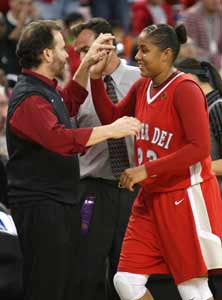 Greeted by coach Kevin Kiernan,
Kaleena Mosqueda-Lewis leaves the
court for the last time with a 123-7
record and two national crowns.
