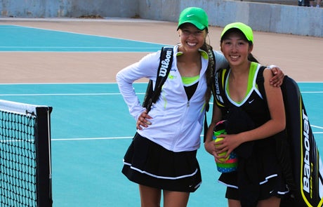 Molly Merrion, left, and Danielle Nguyen didn't buy in to the theory that Farmington tennis was going to be "down" this year. They're undefeated and look to take the state title again.