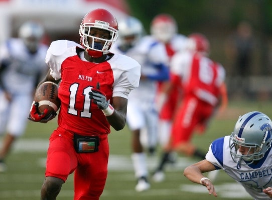 Milton's Dai-Jon Parker is warming up for basketball season by starring for the Eagle football team.