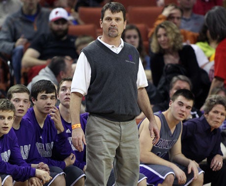 New Douglass boys coach Dayna Westbrook (far right) admits to being "active" on the bench in her role as team mom. She replaces Mark Leuschner (standing, center), who led the Indians to the state championship game last season.