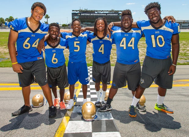 Mainland players (left to right) Marcus Tatum, Adrian Killins, Denzel Houston, Cyrus Fagan, Kevin McCray and Jachai Polite stand at the start/finish line.