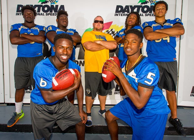 Mainland head coach Scott Wilson poses in Victory Lane with players (front row left to right) Adrian Killins and Danzel Houston; (back row) Jachai Polite, Kevin McCray, Cyrus Fagan and Marcus Tatum.