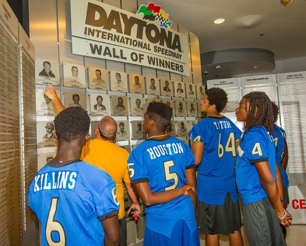 Head coach Scott Wilson and his players check out the Wall of Winners.