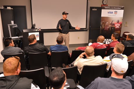 San Francisco 49ers coach Jim Harbaugh met with two dozen Bay Area High School football coaches to talk about leadership, teaching and building relationships.