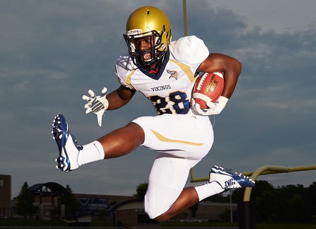 Spartanburg running back Tavien Feaster soars during his team's photo shoot on May 14.