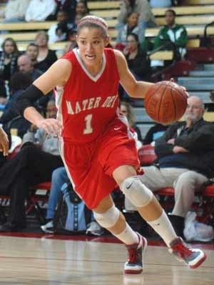 Jordan Adams drives toward two of her 21 points.