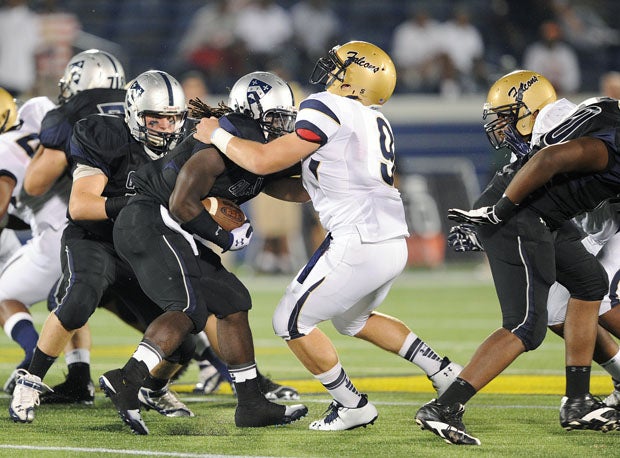 Kyle Snyder (9) wrestled ballcarriers and linemen as a nose guard for Our Lady of Good Counsel.