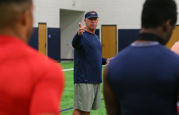 Head coach Terry Gambill gives instruction to players during spring drills.