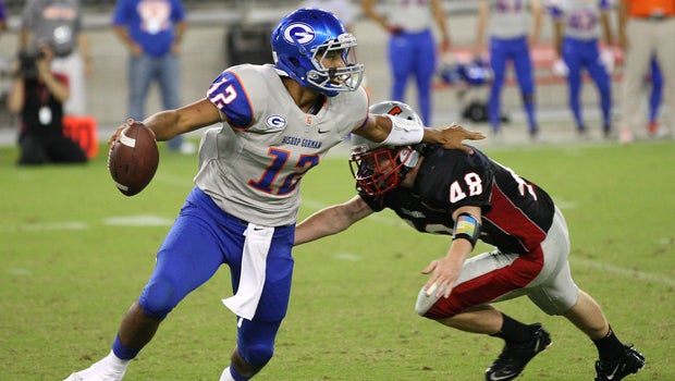 Jarrett Solomon of Bishop Gorman, left, tries to roll away from Chaparral's Ryan Erickson during last year's Sollenberger Classic.