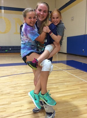 Working with youth at volleyball clinics is just one
of many things that Anderton does to serve her
community.