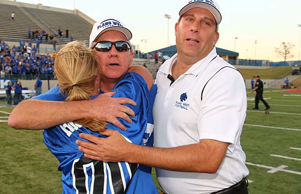 Hughes receives a congratulatory hug from his wife Carolyn after the big playoff victory.