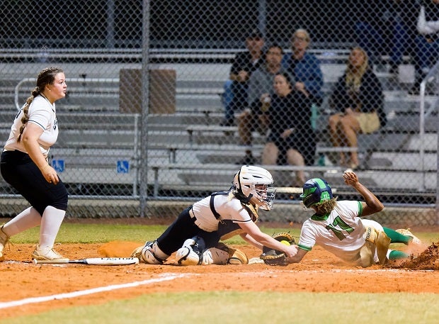 Sumner sophomore Aliyanis Stubbs gets her hand in to score just ahead of the swipe by the Plant catcher as the Plant pitcher looks on. (Photo: Francis Fedor)