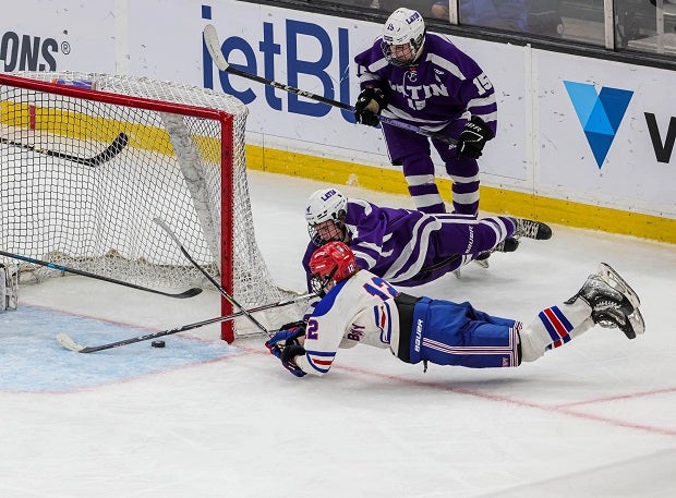 Boston Latin's  Shane Dunning goes all out on defense against Tewksbury's  Tyler Bourgea to keep him from scoring an open netter that would've made Tewksbury lead 3-1. Boston Latin won 4-2 in the MIAA Division 2 State Finals. (Photo: Brian Kelly)