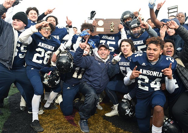 Thomas Brockett (kneeled, center) celebrates winning Connecticut's Class S state title in 2016. The Ansonia coach is going for win No. 200 on Friday night. (Photo: Kevin Pataky)