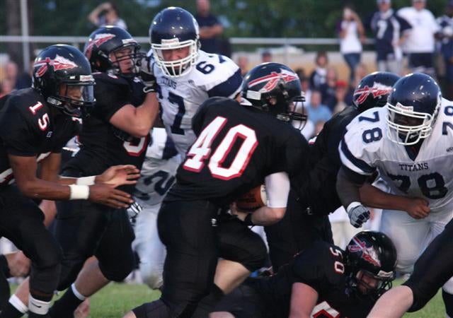 Fort Osage RB Clayton Stewart (40) takes handoff from Pearl.