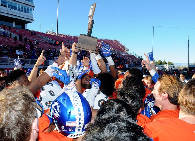 Bishop Gorman players celebrate by hoisting the NIAA 4A state championship trophy at Sam Boyd Stadium in Las Vegas on Saturday afternoon.