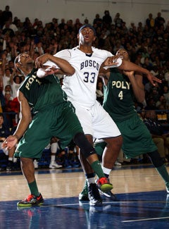 St. John Bosco's Devin Burleson (center)battles Poly players Roschon Prince(left) and Chris Sullivan (right).