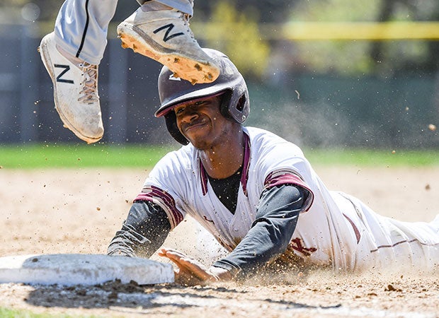Emmanuel Scott of Saint Ignatius College Prep (Ill.) slides safely into third against Fenwick.