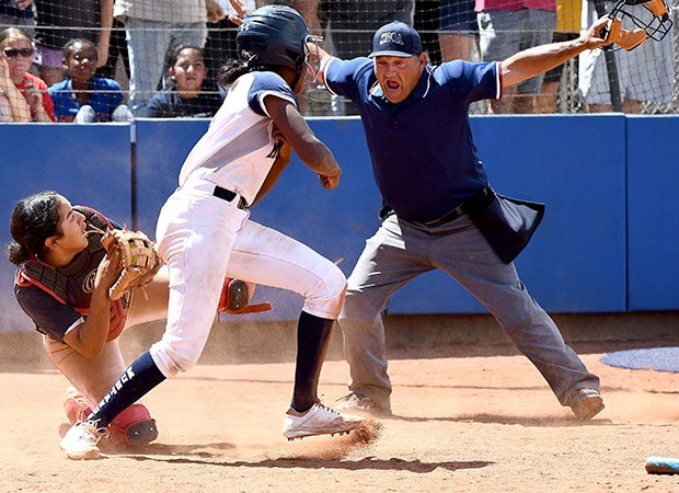 A Shadow Ridge (Nev.) player is called safe by the home plate umpire for the winning run against Coronado in the NIAA 4A title game.