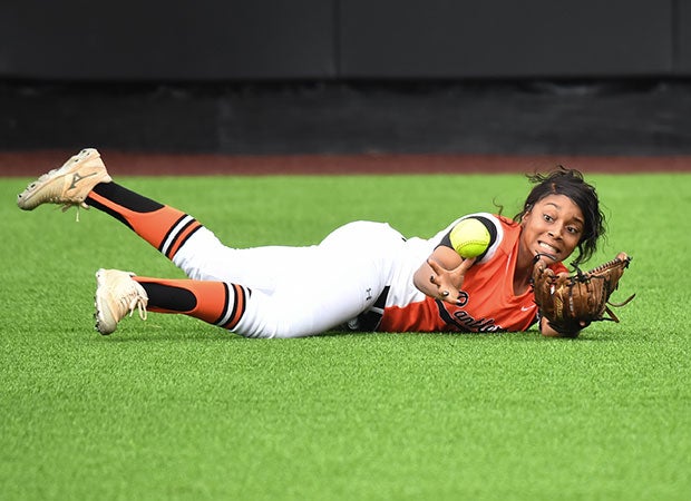 A St. Pius X (Texas) outfielder attempts to make a diving one-handed juggling catch against Incarnate Word in a TAPPS Division 1 playoff game.