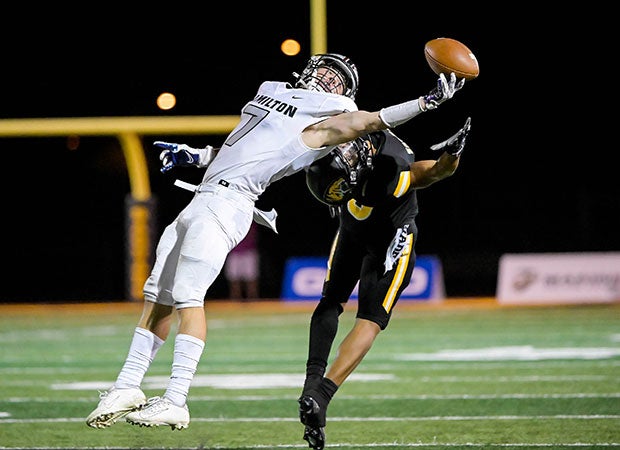 Hamilton (Ariz.) safety Jack Howell reaches in an attempt to make one-handed interception in front of a Sagauro receiver.