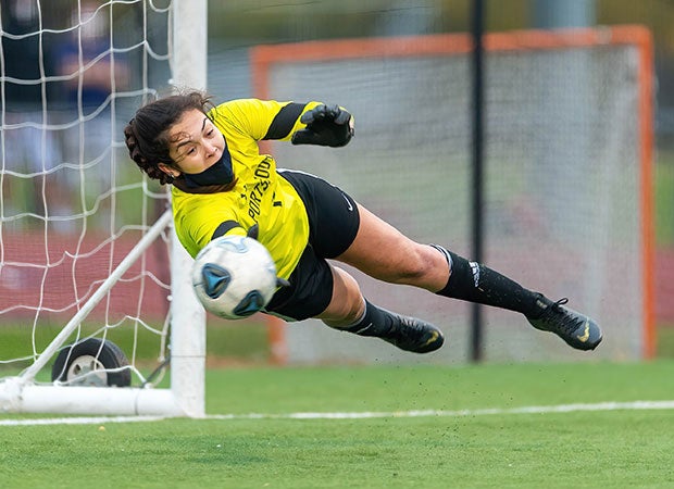 Goalie (N.H.) Sophia Rinalli of Portsmouth makes a diving save in a game against Exeter. 
