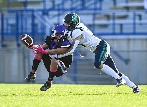 Arvada West (Colo.) cornerback AJ St. James looks for an interception in front of intended receiver Sam Jacobs of ThunderRidge. 