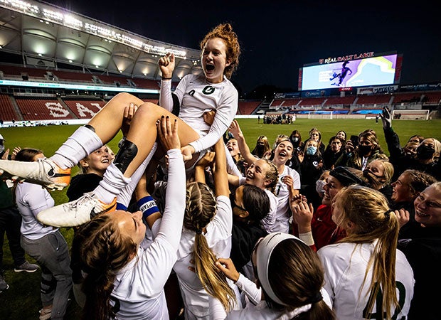 The Olympus (Utah) soccer team raises midfielder Emma Neff aloft after scoring the game-winning, overtime goal in the UHSAA 5A championship game at Rio Tinto Stadium.