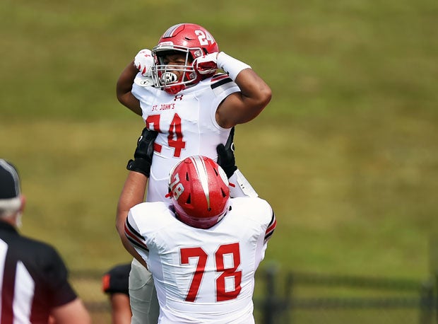 Colby McDonald is lifted into the air by offensive lineman Colin Henrich.