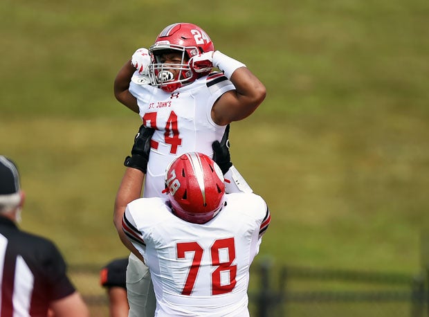 Colby McDonald is lifted into the air by offensive lineman Colin Henrich. 