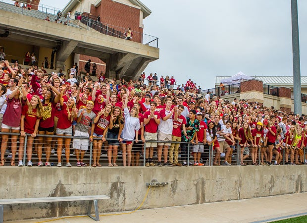 Fans cheer during a recent high school football game at the Berry Center.
