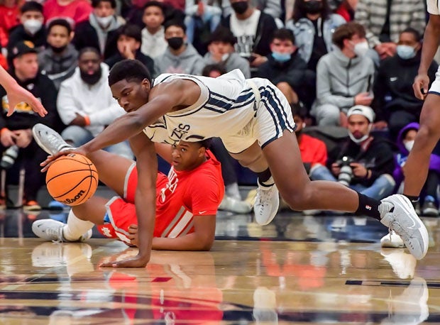 Sierra Canyon's Kijani Wright (11) and Mater Dei's Tee Bartlett are on the floor for a loose ball.