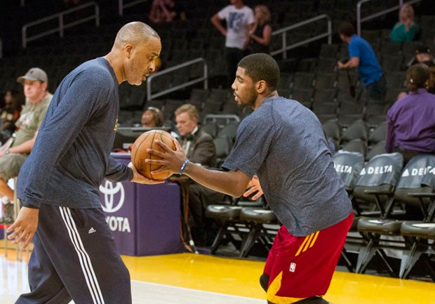 Phil Handy (left) works with Cavaliers point guard Kyrie Irving.