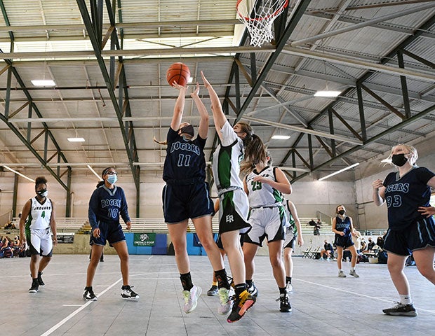 A Rogers player takes a shot during one of the two junior varsity girls games.