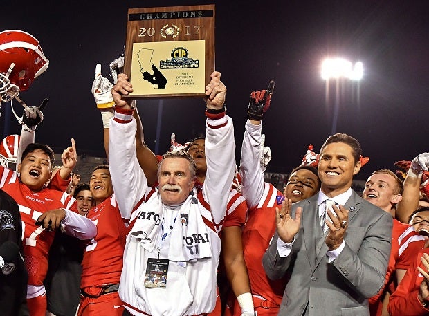 Mater Dei's Bruce Rollinson holds the CIF Southern Section championship plaque after the Monarchs' win over St. John Bosco.