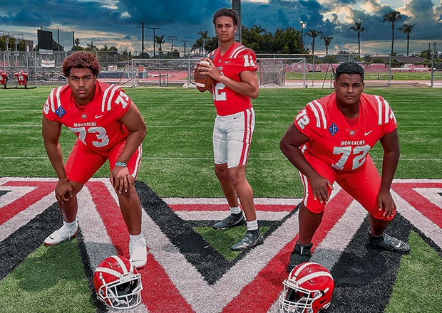 Top 100 offensive tackles Brandon Baker (left) and DeAndre Carter (right) flank Mater Dei quarterback Elijah Brown, who won his first 29 games under center in one of the nation's most high-profile programs. (Photo: Louis Lopez)
