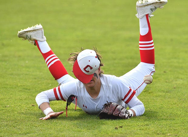 A Fort Worth Christian (Texas) outfielder makes a diving attempt against Bay Area Christian in the Texas Private School Classic.     
