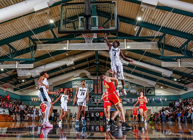 Xavion Brown of Sheldon (Calif.) skies over a Jesuit defender for a dunk.