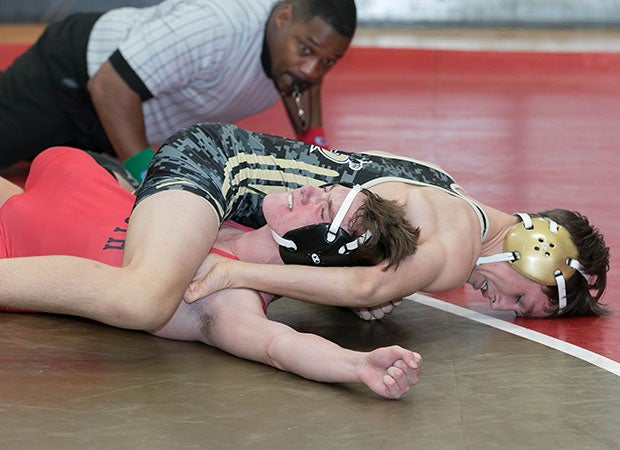 A Providence (N.C.) wrestler works for the pin against a South Mecklenburg opponent while competing in the So Meck 7 4A Conference Tournament.