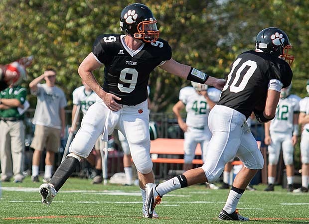 Amputee quarterback Jacob Rainey takes the field for Woodberry Forest (Va.) on Sept. 7.